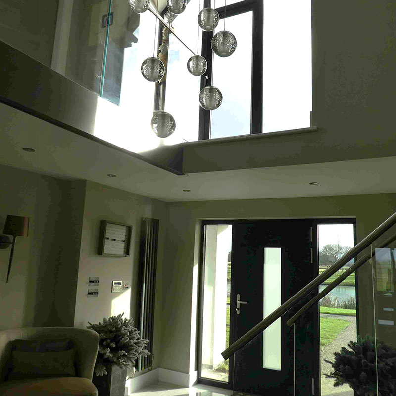 Photo shows interior of detached home extension with gable windows incorporated in the design & architect services.