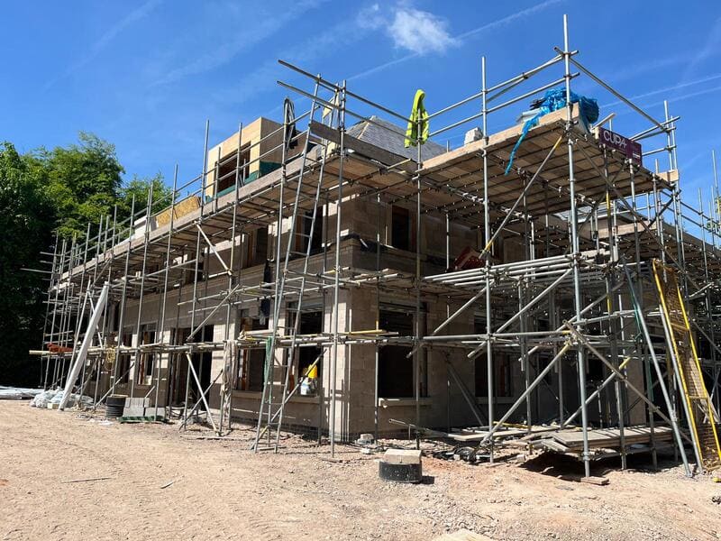 New build 12,000 sq ft home under construction, surrounded by scaffolding, in Appleton, Warrington